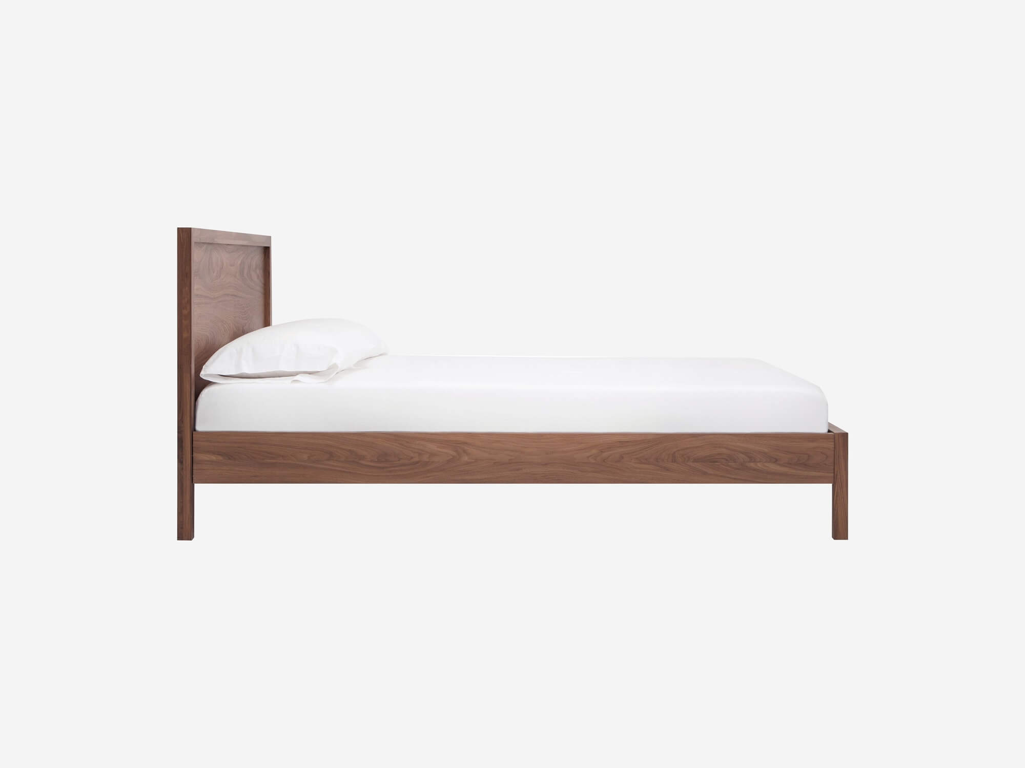 Side view of the EQ3 Marcel platform bed frame in walnut